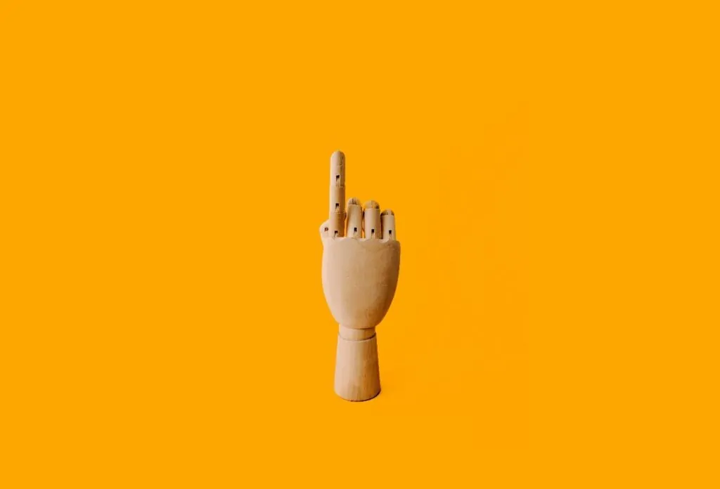 A wooden hand pointing upwards representing VC-decision making 
